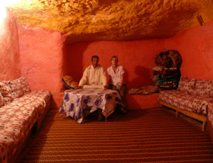 man and woman in cave home in morocco