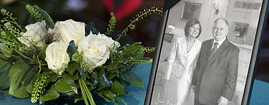 A bouquet of white roses lies next to a picture of former Polish President Lech Kaczynski and his wife Maria at the Polish embassy in Berlin, Sunday, April 11, 2010. (AP Photo/Gero Breloer)