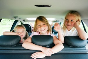 Three kids in a car's backseat