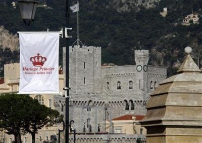 A flag announcing the wedding of Prince Albert II of Monaco and his fiancee Charlene Wittstock is seen with Monaco Palace in the background. (Reuters)