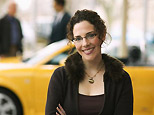 WOman smiling in front of car (Corbis)