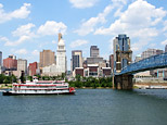 Replica steamboat travels down the Ohio River in front of the Cincinnati skyline (iStockPhoto)