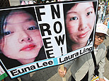 A South Korean protester displays portraits of American journalists detained in North Korea as they shout slogans during a rally on June 4, 2009 in Seoul, South Korea. (AP)