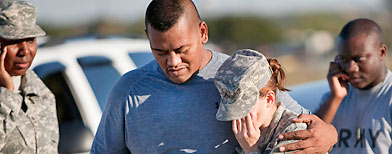 Sgt. Fanuaee Vea (L) embraces Pvt. Savannah Green outside Fort Hood on November 5, 2009 in Killeen, Texas.   (Ben Sklar/Getty Images)