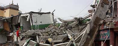 Building blocks are scattered near a destroyed building. (AP)