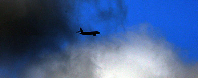 A Boeing 757 flies through the clouds leaving Newcastle International Airport, England. (AP/Scott Heppell)