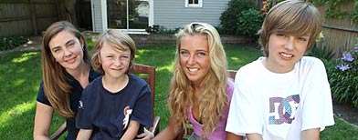 Kris Sonnenberg, 38, left, sits with her 8-year-old son Mike, 17-year-old daughter Elise, and 12-year-old son Charlie in their backyard Tuesday, May 25, 2010 in Chicago. (AP Photo/Kiichiro Sato)