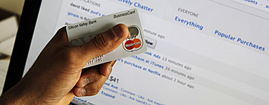 The founder of a legal online purchasing company poses with his credit card in front of his Web site, Blippy, at his office in Palo Alto, Calif., Feb. 16, 2010. (AP Photo/Paul Sakuma)