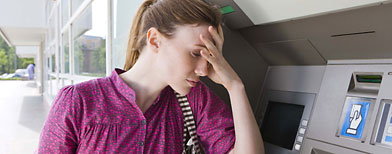 Woman at ATM machine (Jupiter Images/ThinkStock)