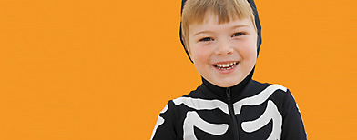 Boy (6-7) wearing skeleton costume, portrait (Photo by Stockbyte)