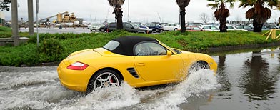 A Porsche navigates a flooded drive in Oakland, Calif. (AP/Noah Berger)