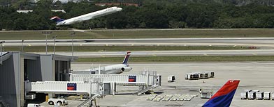 A Delta jet takes off as others are prepared for flights at Tampa international Airport. (AP Photo/Chris O'Meara)