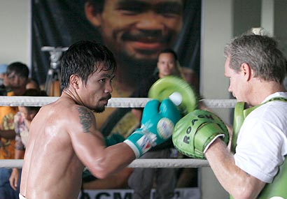 Manny Pacquiao spars with coach and trainer Freddie Roach in the Philippines.