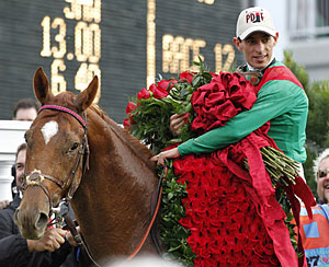 John Velazquez holds the Blanket of Roses.