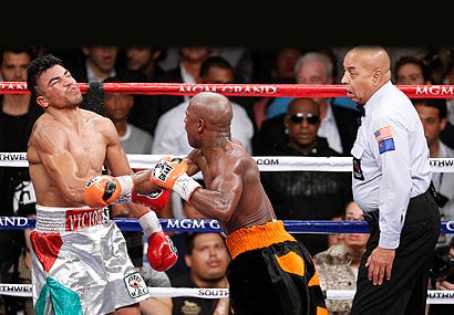 Floyd Mayweather Jr. floored Victor Ortiz with a combination to win the WBC welterweight title.