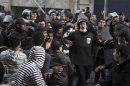 Riot police move in to detain anti-Mursi protesters during clashes in Simon Bolivar Square, which leads to Tahrir Square, in Cairo