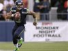 Seahawks quarterback Wilson runs for a gain against the Packers during the second quarter of their Monday night NFL football game at Centurylink Field in Seattle