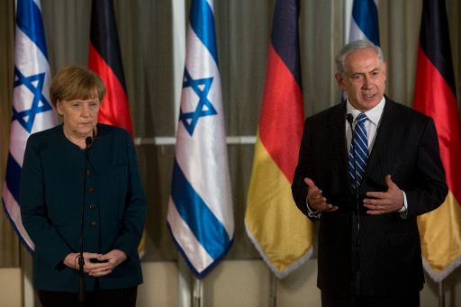 Germany's Chancellor Angela Merkel (L) listens as Israeli Prime Minister Benjamin Netanyahu speaks during a joint press conference at the prime minister's residence in Jerusalem on February 24, 2014