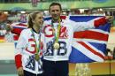 Laura Trott, left, and her fiance Jason Kenny, right, both of Britain, pose with their gold medals at the Rio Olympic Velodrome during the 2016 Summer Olympics in Rio de Janeiro, Brazil, Tuesday, Aug. 16, 2016. Kenny won the men's keirin cycling final and Trott won gold in the women's omnium race.(AP Photo/Patrick Semansky)