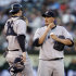 New York Yankees' Freddy Garcia, right, speaks with catcher Chris Stewart in the fourth inning of a baseball game against the Oakland Athletics, Thursday, July 19, 2012, in Oakland, Calif. (AP Photo/Ben Margot)