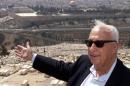 Ariel Sharon gestures towards Jerusalem's Old City on July 24, 2000, on the Mount of Olives during a rally to protest any land concessions in Jerusalem to the Palestinians, when he was leader of the opposition in Israel