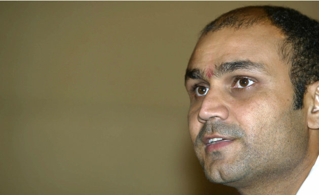 Indian cricketer Virender Sehwag gives a