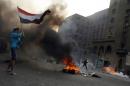 Tires burn as Egyptian Muslim brotherhood and supporters of ousted president Mohamed Morsi take part in clashes with riot police along Ramsis street in downtown Cairo, on October 6, 2013