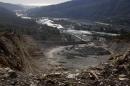 Excavators move earth at a quarry near Akhshtyr village in Sochi, Thursday, Oct. 24, 2013. As a centerpiece of its Olympic bid, Russia trumpeted a 