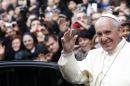 Pope Francis waves as he leaves Rome's Jesus' Church to celebrate a mass with the Jesuits, on the occasion of the order's titular feast, Friday, Jan. 3, 2014. (AP Photo/Riccardo De Luca)