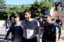 Major Sukru Seymen, one of the military personnel suspected of being involved in the coup attempt, is brought to a court house as he is accompanied by police officers and other detaniees in Mugla