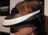 A model wears a 60,000 yen ($800) HMZ personal 3-D viewer during a news conference at Sony headquarters in Tokyo Wednesday, Aug. 31, 2011. Sony Corp. says it will start selling a head mounted display that provides a 3-D theater of music videos, movies and games, targeting people who prefer solitary entertainment rather than sitting in front of a TV with family or friends. (AP Photo/Itsuo Inouye)
