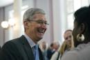 FILE - Apple chief executive and Alabama native Tim Cook laughs with a group before an Alabama Academy of Honor ceremony at the state Capitol in this Oct. 27, 2014 file photo taken in Montgomery, Ala. In an essay written for Bloomberg Businessweek, and published Thursday Oct. 30, 2014 Cook says that while he never denied his sexuality, he never publicly acknowledged it, either. (AP Photo/Brynn Anderson, File)