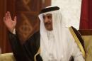 Qatar's Emir Hamad al-Thani talks with Algeria's Senate President Bensalah upon his arrival at Algiers airport