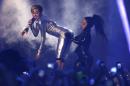 Miley Cyrus, left, and a dancer perform at the 2013 MTV Europe Music Awards in Amsterdam, Netherlands, Sunday, Nov. 10, 2013. (AP Photo/Peter Dejong)