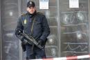 A police officer stands in front of the cultural center where an alleged shooter killed one person on Saturday in Copenhagen, Denmark, Monday, Feb. 16, 2015. The shooter was killed by police who believe he also shot a second person at a Jewish synagogue. (AP Photo/Michael Probst).