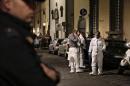 CORRECTS LAST NAME FROM OSLEN TO OLSEN- Italian forensic police officers stand outside an apartment where 35-year-old American woman Ashley Olsen was found dead, in Florence, Italy, Saturday, Jan. 9, 2016. Italian police say the woman has been found slain in her apartment with bruises and scratches on her neck, but wouldn't comment on Italian news reports that the woman had been strangled until an autopsy is performed. (Maurizio Degl'Innocenti/ANSA via AP)