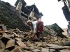 A Nepalese woman removes bricks of the damaged house to make way for pedestrians after an earthquake in Katmandu, Nepal, Monday, Sept. 19, 2011. Rescue workers raced Monday to clear roads blocked by mudslides as they scrambled to reach remote villages cut off after a powerful earthquake of magnitude 6.9 shook northeast India, Nepal and Tibet. (AP Photo/Niranjan Shrestha)