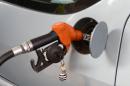 An employee refuels a vehicle with fuel at a petrol station in Rabat, Morocco on September 16, 2013
