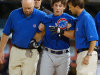 FILE - This July 9, 2005 file photo shows Chicago Cubs rookie Adam Greenberg, center, being helped by Cubs trainers after being hit in the helmet by the first pitch he faced in the major leagues, from Florida Marlins relief pitcher Valerio Do Los Santos, in Miami. Just called up by the Cubs, he got beaned by a 92 mph fastball on the first pitch and never set foot in a big league batter's box again.  (AP Photo/Steve Mitchell, File)