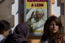 Pedestrians walks past a poster with an image of a waving Pope Benedict XVI, in Leon, Mexico, Thursday March 22, 2012. It's been a decade since the former Pope John Paul Paul II visited Mexico; his fifth and final trip to the country. His successor, Benedict, arrives Friday. The Pope will hold Sunday Mass in Silao, Mexico, against the backdrop of the 60-foot-tall hilltop statue of Christ the King, before leaving for Cuba on Monday. (AP Photo/Eduardo Verdugo)