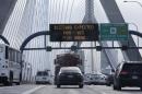 With a road sign warning of an expected blizzard, morning commuters travel across the Zakim Bunker Hill Bridge into downtown Boston., Monday, Jan. 26, 2015. The Boston area is expected to get hit with about two feet of snow in the winter storm. (AP Photo/Charles Krupa)
