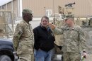 U.S. Defense Secretary Panetta talks with U.S. Army Major General Abrams and Command Sergeant Major Watson during a visit to Kandahar Airfield in Kandahar
