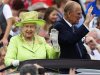 Britain's Queen Elizabeth waves to members of the public as she and her husband Prince Philip drive through the Stormont estate in Belfast, Northern Ireland