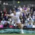 Andy Murray of Britain hits a return to Jo-Wilfried Tsonga of France during their men's semi-final tennis match at the Wimbledon tennis championships in London