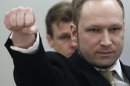FILE This Monday, April 16, 2012 file photo shows Anders Behring Breivik gesturing as he arrives at the courtroom in Oslo, Norway. Mass murderer Anders Behring Breivik's shocking testimony to a Norwegian court has revived a debate about how much of a public platform mass-murderers should be given in trials. Such atrocities are often waged for attention and carried out in the name of political or religious goals, and a trial gives perpetrators more of what they crave: a huge audience. (AP Photo/Frank Augstein)