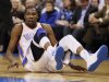 Oklahoma City Thunder forward Kevin Durant slides to the floor on a play against the Houston Rockets in the second half of NBA basketball game in Oklahoma City