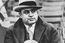 FILE - In this Jan. 19, 1931 black-and-white file photo Chicago mobster Al Capone watches a football game in Chicago. For a time, the Internal Revenue Service inspired awe and admiration in Americans, not just trepidation and lame jokes about death and taxes. Everyone loved it when revenue agents put away Capone, the Chicago underworld's master of brutality and bribe, in a coup so spectacular it scared other gangsters straight. But there's little love for the IRS anymore, and there hasn't been for ages. (AP Photo/File)