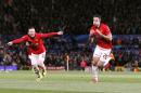 Manchester United's Robin van Persie, right, celebrates scoring their third goal, and his hat-trick against Olympiakos, with team-mate Wayne Rooney, left, during the UEFA Champions League, Round of 16, second leg match at Old Trafford, Manchester, England, Wednesday March 19, 2014. (AP Photo / Peter Byrne, PA) UNITED KINGDOM OUT - NO SALES - NO ARCHIVES