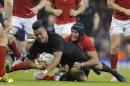 New Zealand's Julian Savea is tackled by France's captain Thierry Dusautoir during the Rugby World Cup quarterfinal match between New Zealand and France at the Millennium Stadium in Cardiff, Wales, Saturday, Oct. 17, 2015. (AP Photo/Christophe Ena)