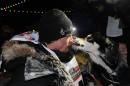 Dallas Seavey gets a kiss from one of his dogs after winning the 2014 Iditarod Trail Sled Dog Race in Nome, Alaska, Tuesday, March 11, 2014. (AP Photo/The Anchorage Daily News, Bob Hallinen) LOCAL TV OUT (KTUU-TV, KTVA-TV) LOCAL PRINT OUT (THE ANCHORAGE PRESS, THE ALASKA DISPATCH)